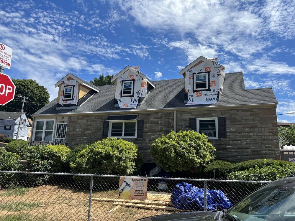 Three new front dormers framed and wrapped on the Cape