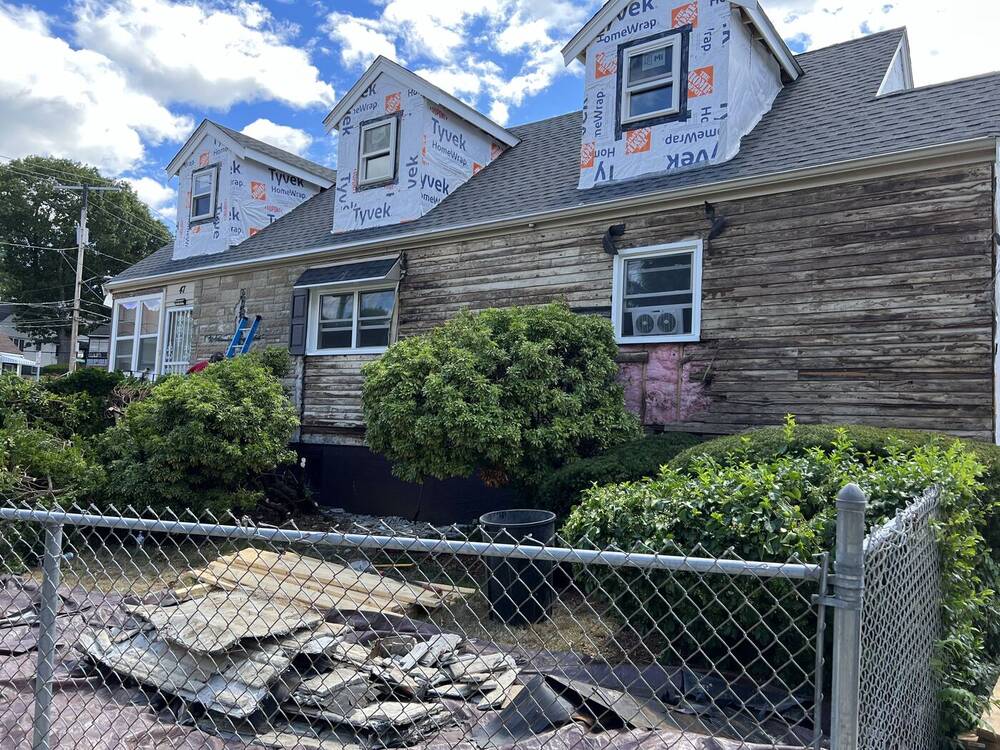 Front wall stripped of old siding down to the board sheathing