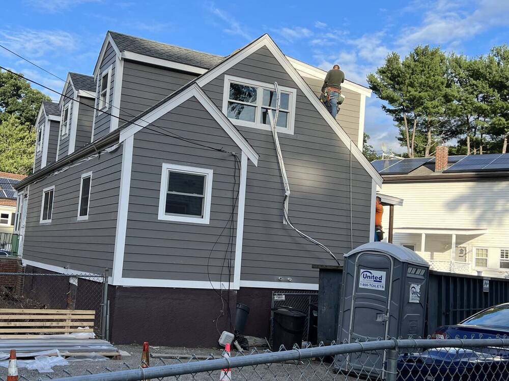 Rear of the house with new gray siding and white trim