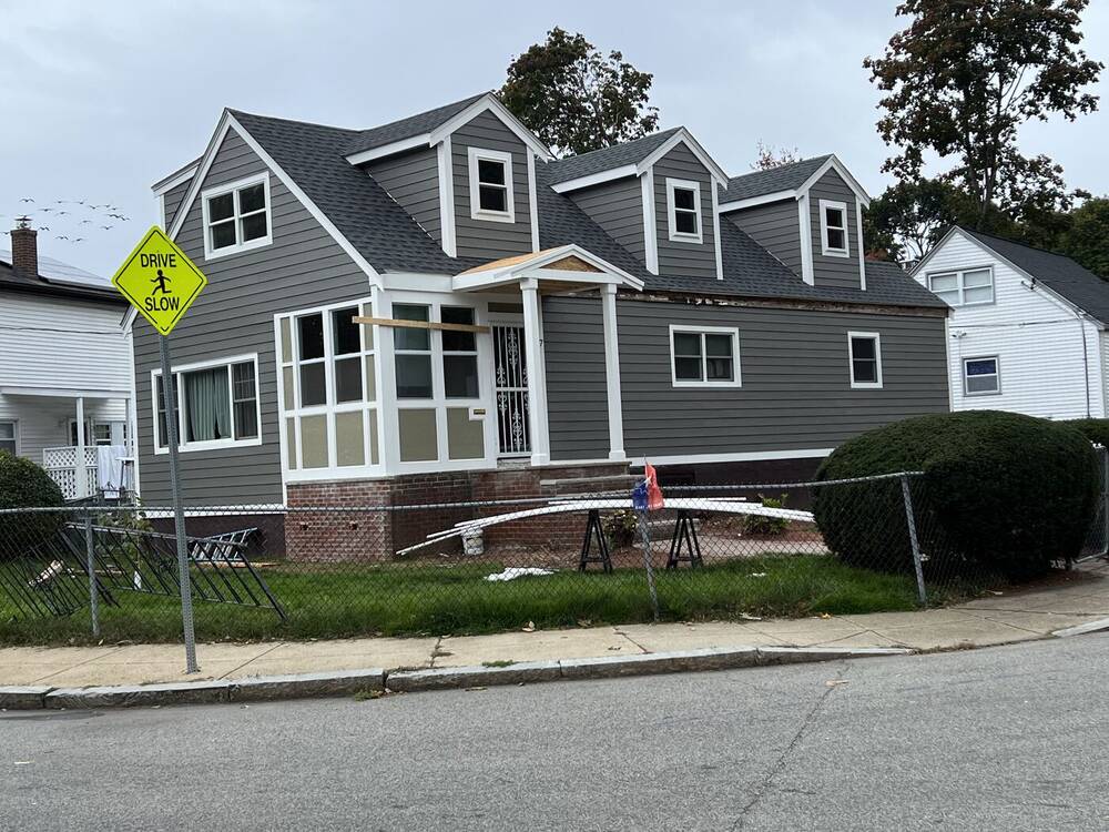 Front of the Cape with new siding, roof and dormers nearly complete