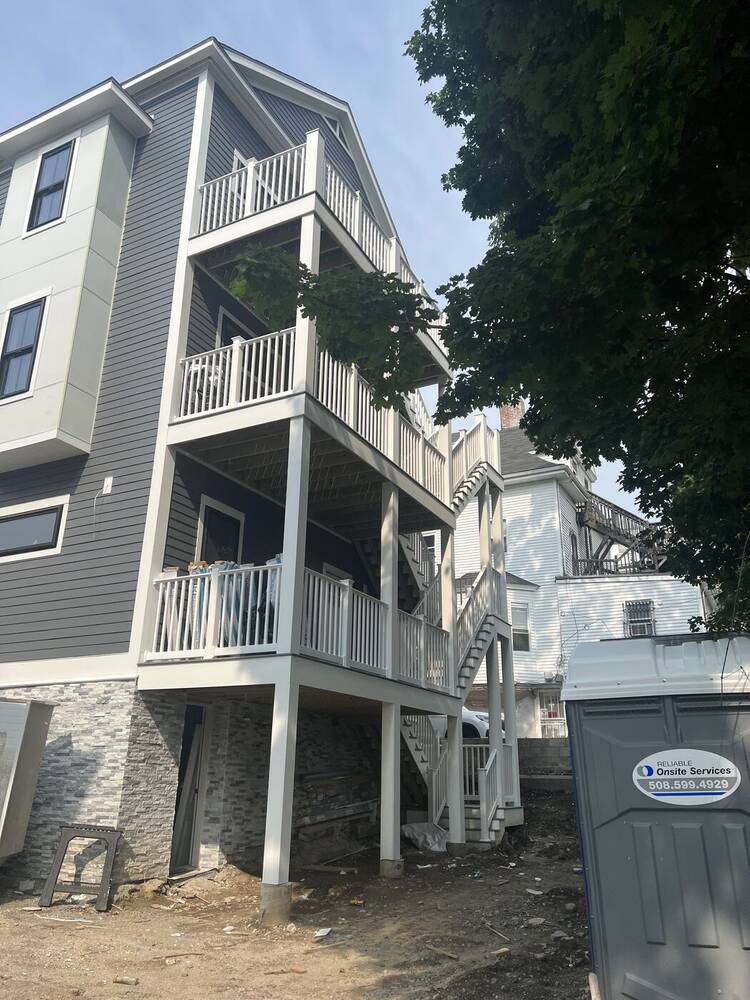 Rear of the house with three levels of white porches