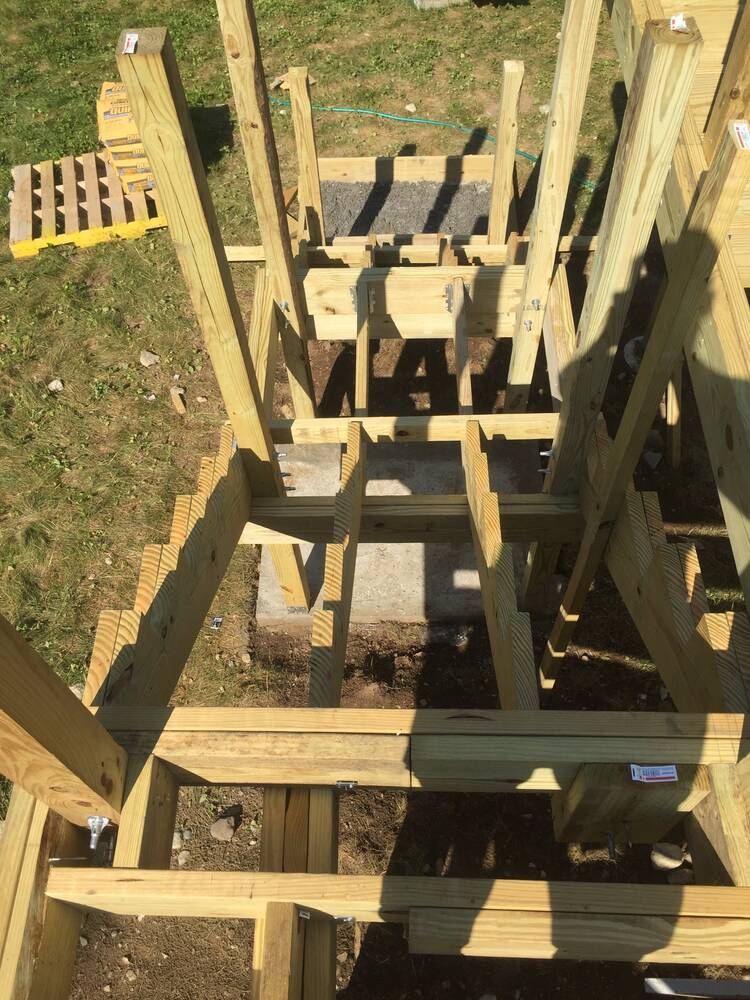 Pressure-treated framing for the new stairs and landing on concrete pads
