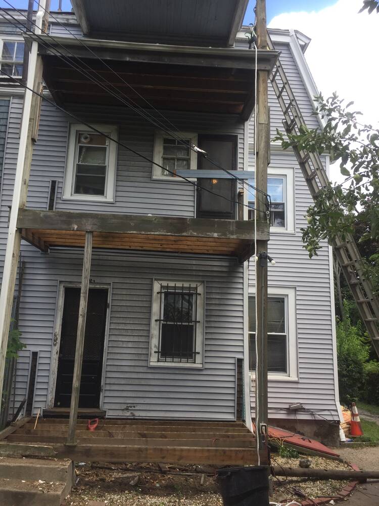 Rear porches before, with rotted framing and the old ground-level deck removed