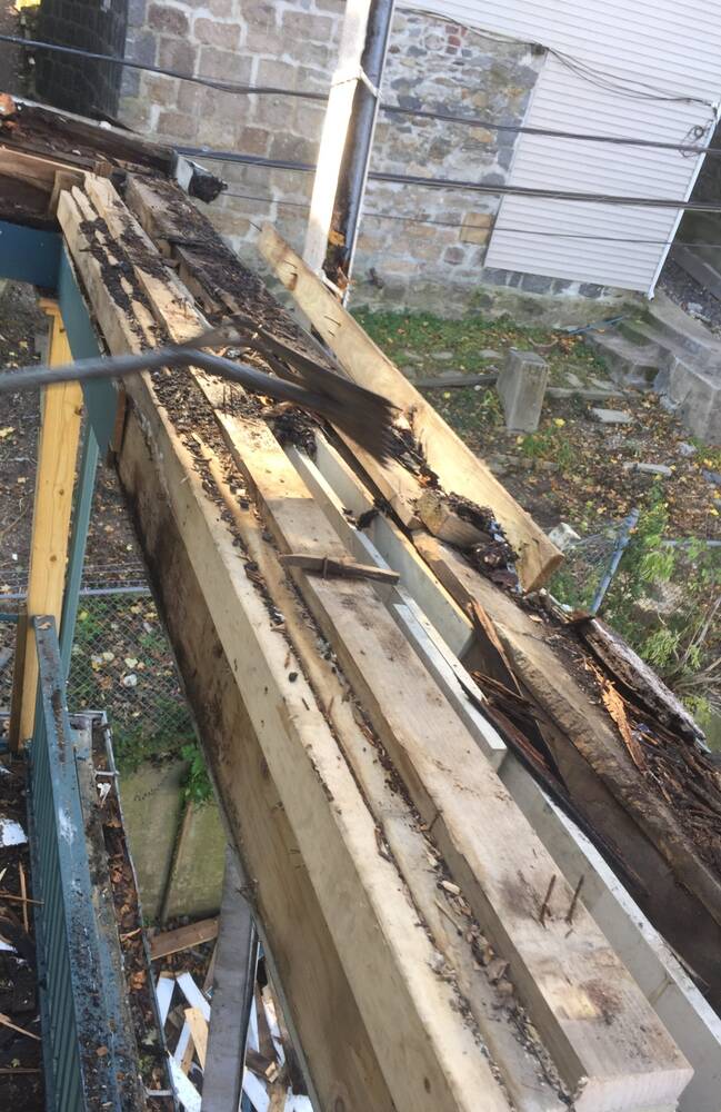 Crew prying out the rotted porch beams and joists