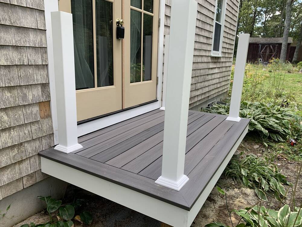 Gray composite landing at a French door, before railings