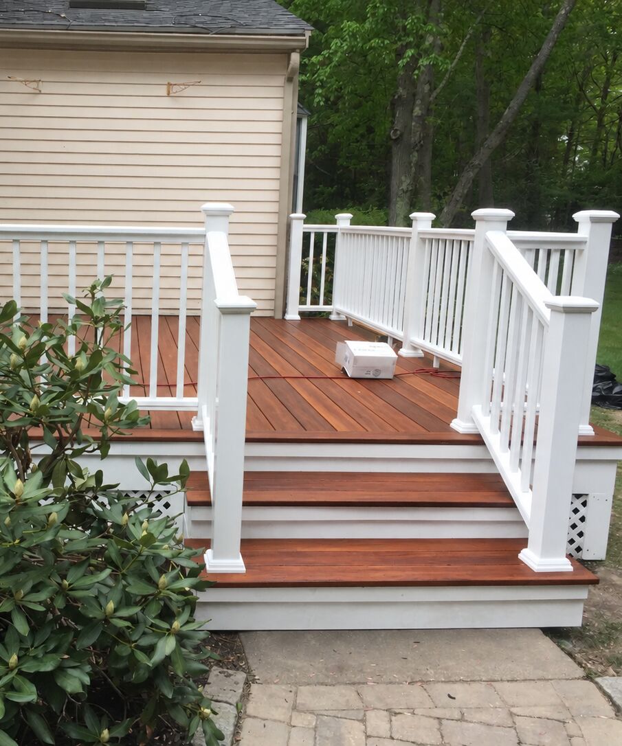 Mahogany deck with wide stairs and white railings
