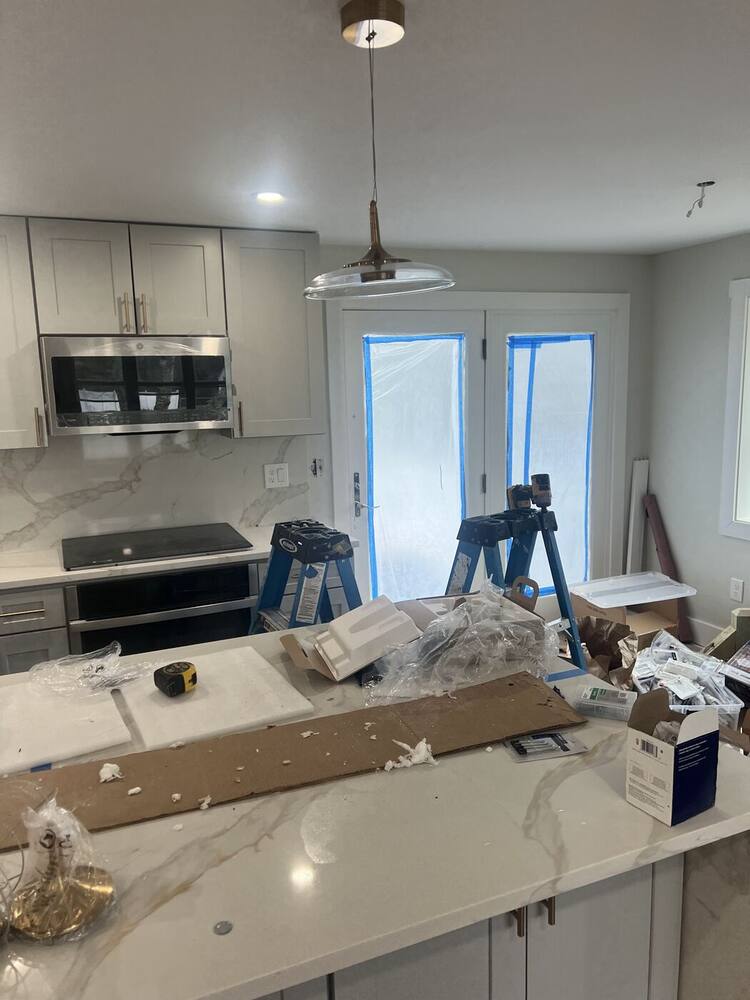 Slab backsplash, pendant lights and appliances going in