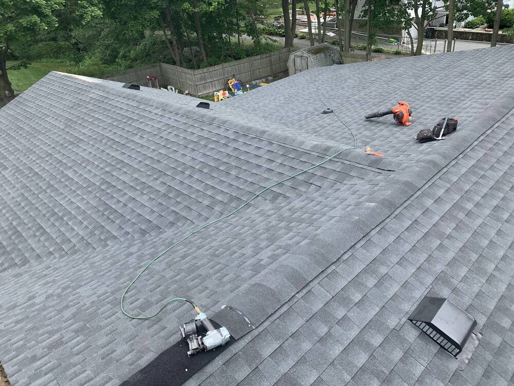 New gray architectural shingles with roof vents installed